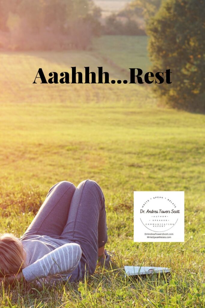 woman laying in a field with trees in the background; says "aaahhh, rest" with author logo in bottom right corner
