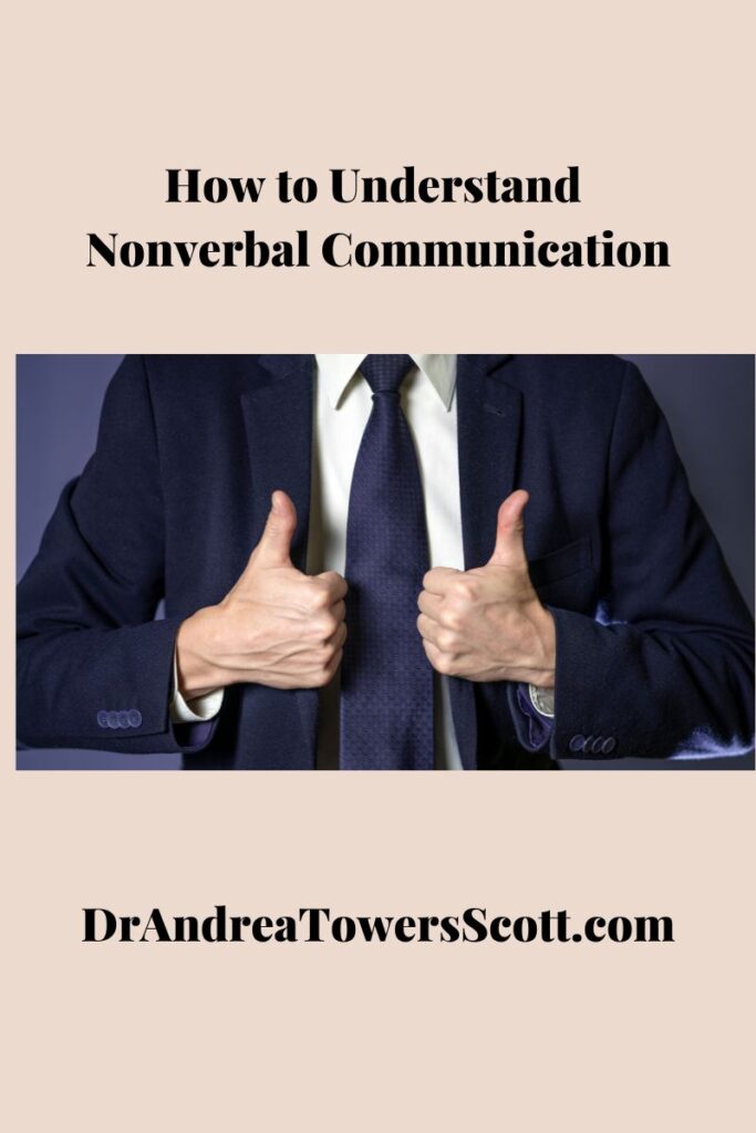 picture of a man in a suit with two thumbs up; title "how to understand nonverbal communication" at the top with author website at the bottom - Dr Andrea Towers Scott dot com